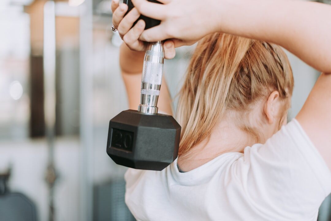middle aged woman lifting weights